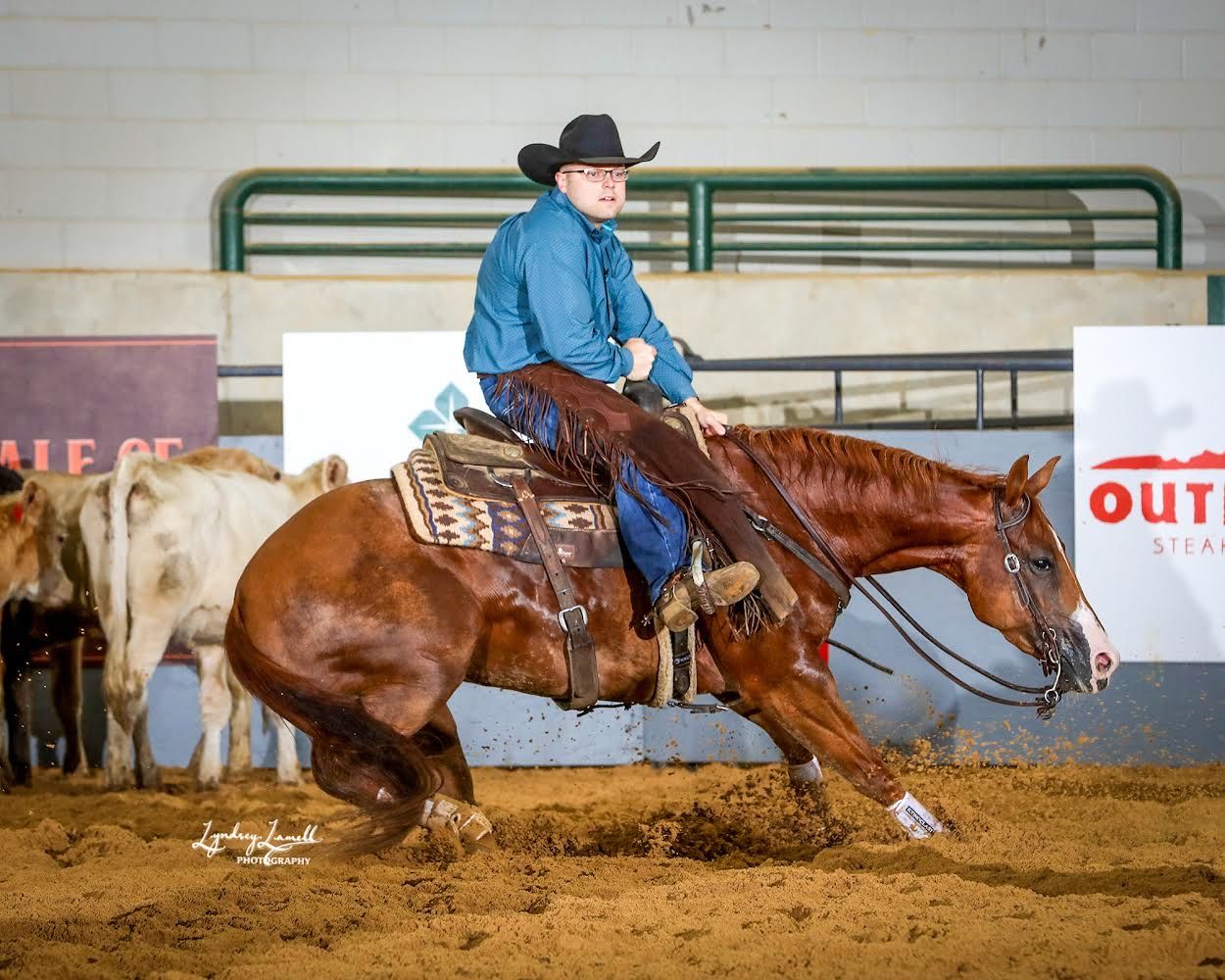 Rider working a cow in the cutting pen